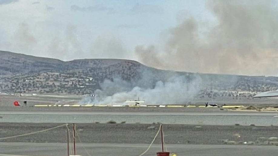 A picture showing smoke in the distance after a plane crash in Reno