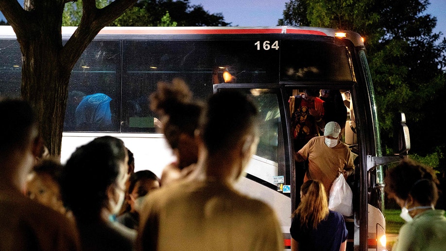Migrants boarding a bus heading to Washington, D.C.