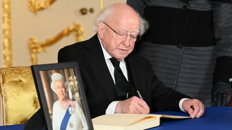 The President of Ireland signs a book of condolences