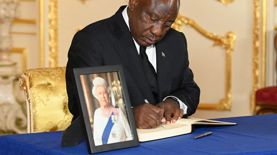 South Africa's President Cyril Ramaphosa signs a condolence book