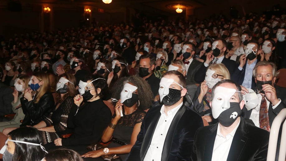 A group of people wearing Phantom of the Opera masks