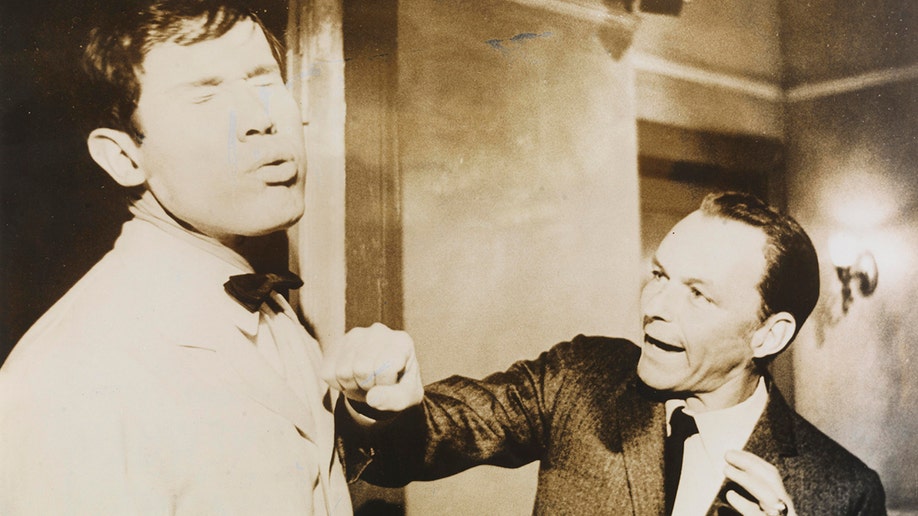 Henry Silva getting punched on a movie set