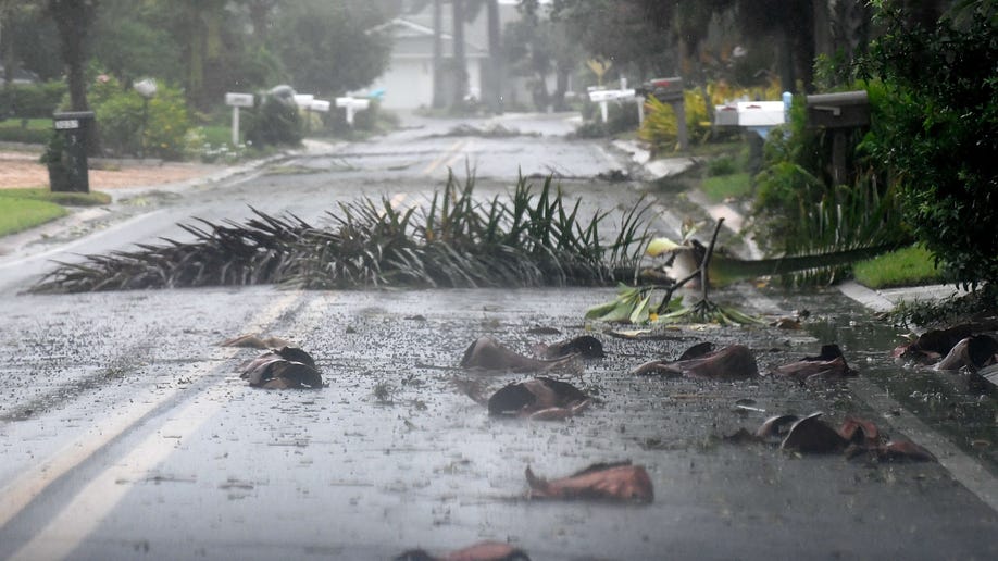 Debris is littered across a Florida street during Hurricane Ian