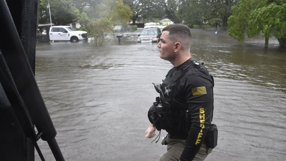 Officers in floodwaters in Florida