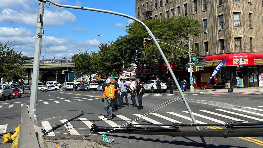 First responders attend to scene where crane fell on a car in New York