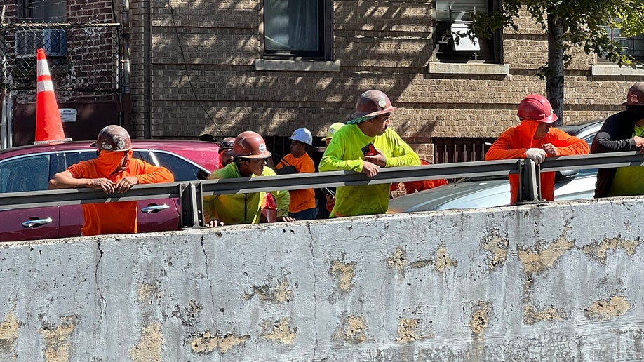 First responders attend to scene where crane fell on a car in New York