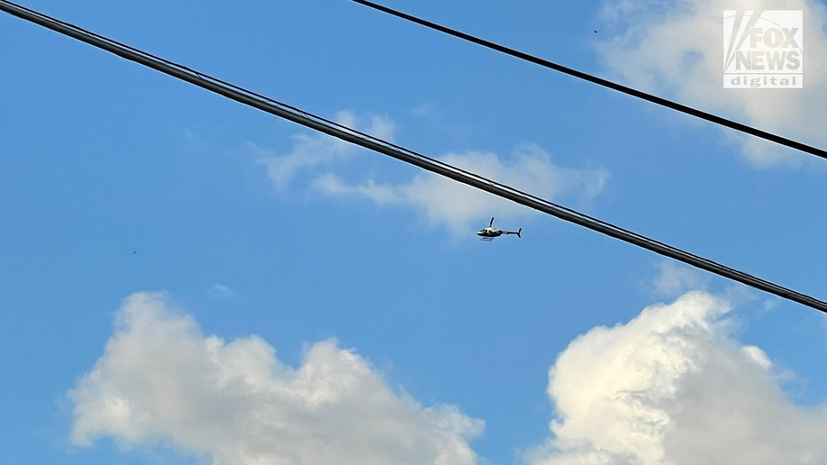 Police helicopter hovers over a crime scene in the search for Eliza Fletcher