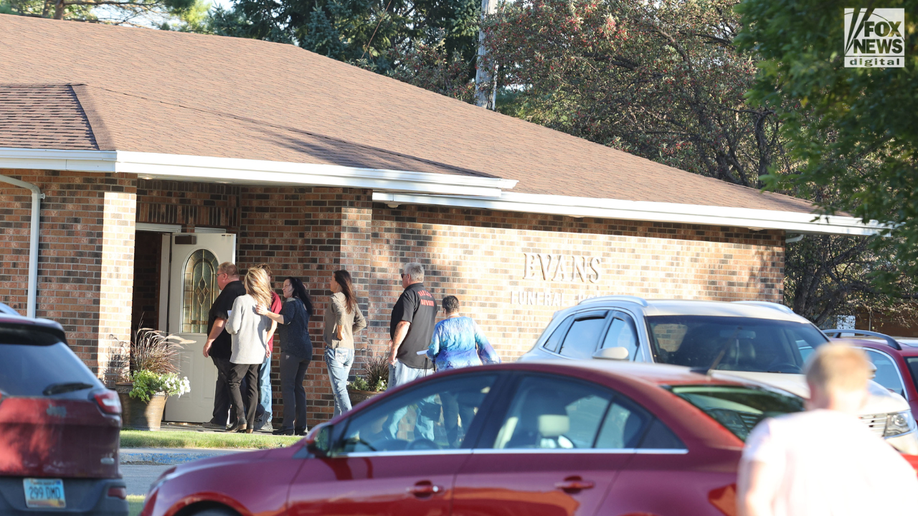 People are seen walking into the prayer service for Cayler Ellingson