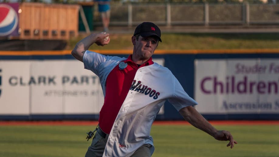 Man throwing baseball at game