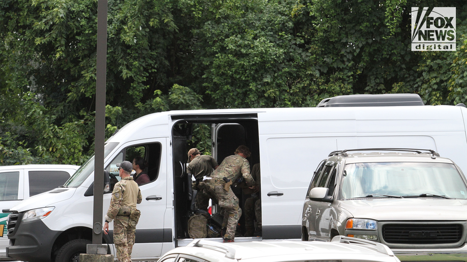 Men in camo in van outside the search for Eliza Fletcher