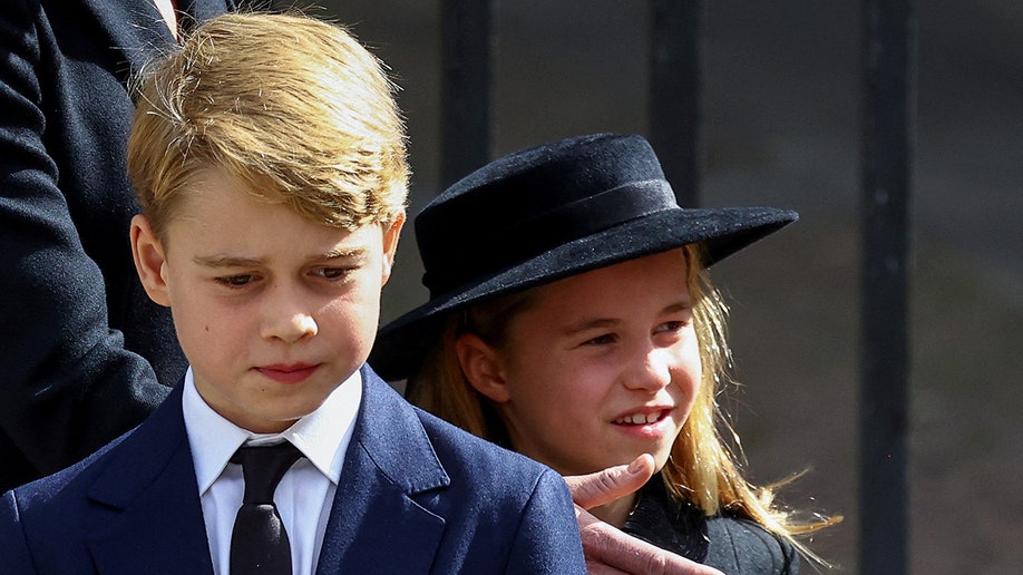 Prince George walks out front of Princess Charlotte during Queen Elizabeth's state funeral.