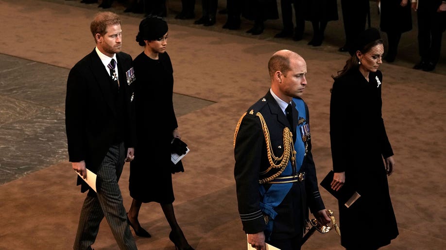 Kate, William, Harry, and Meghan look solemn as they walk out of Westminster Hall