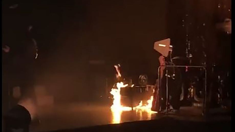 A fire burns on stage at a Panic at the Disco concert