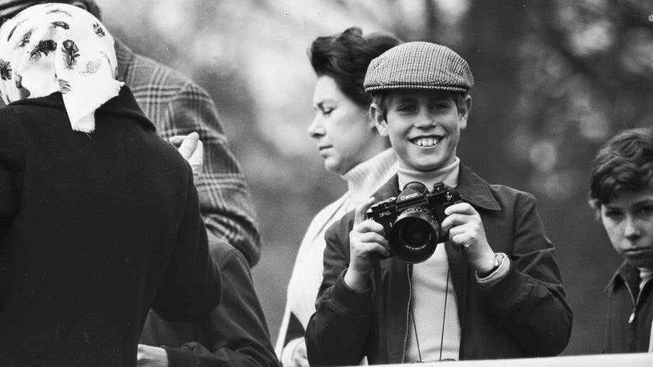 Young Prince Edward holding a camera