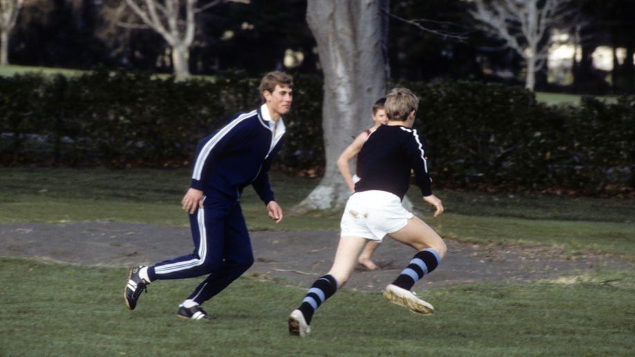 Young Prince Edward running on a field