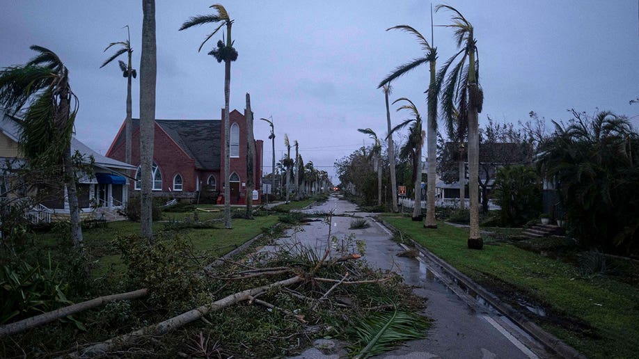 Trees and debris lay strewn across a Punta Gorda street as Hurricane Ian devastates Florida