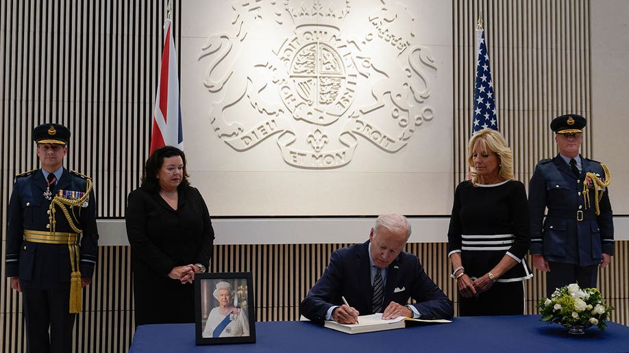 Biden signs a condolence book at the British Embassy in Washington D.C.