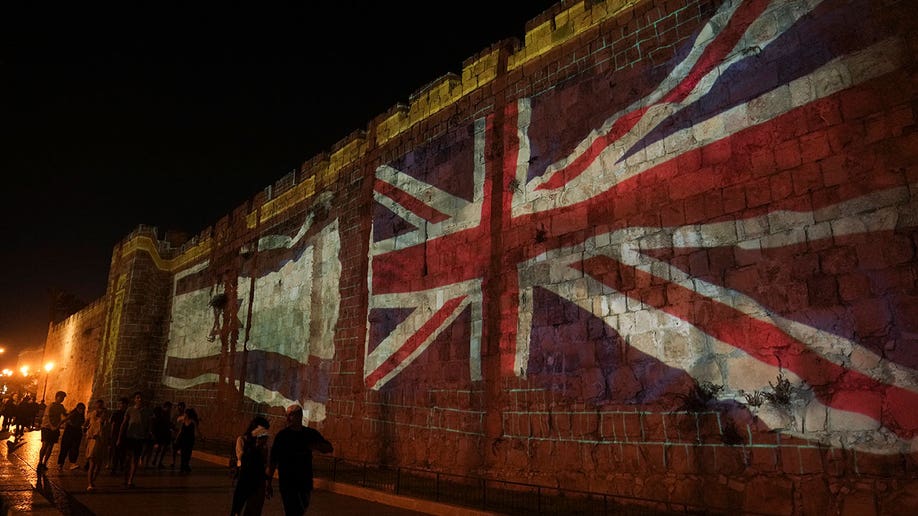 Images of the Union and Israeli flag are projected on the walls of Jerusalem's Old City