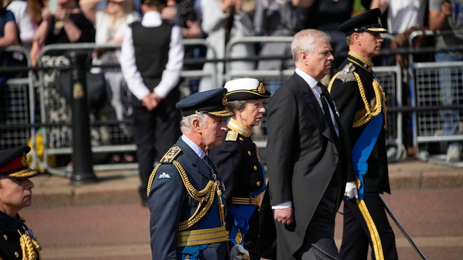 Charles III, Princess Anne, Prince Edward, and Prince Andrew walk in line during queen's procession
