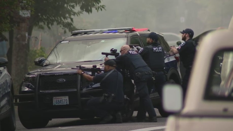 Seattle police train weapons on suspect