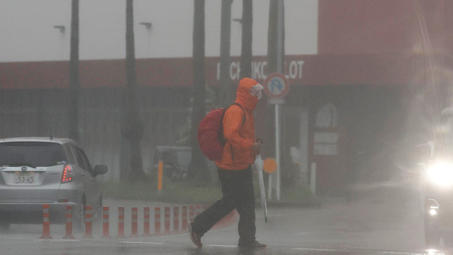 People makes one's way through the rain in Miyazaki