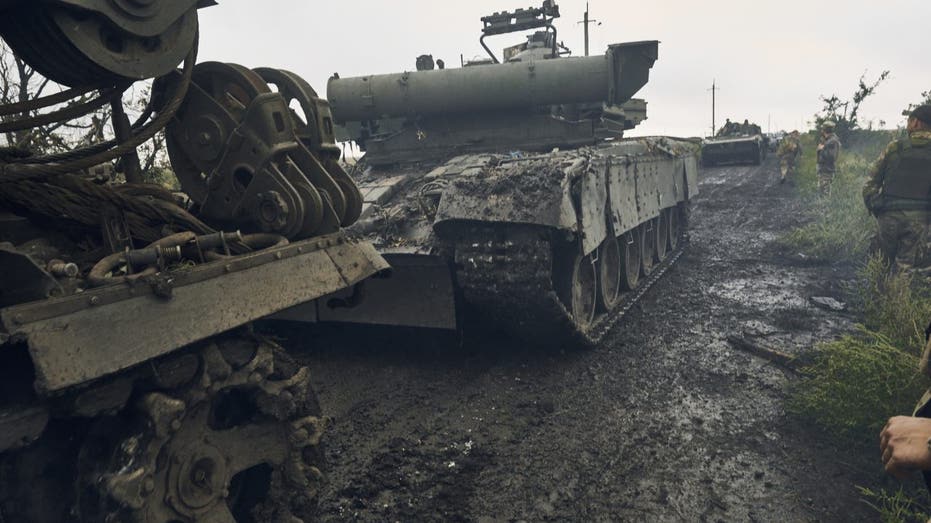 Ukrainian military vehicles move on the road in the freed territory in the Kharkiv region,