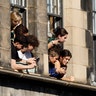 Members of the public watch from buildings as the procession of Queen Elizabeth II's coffin