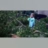 A woman covers her mouth in shock as hurricane Ian damages mobile home in Florida