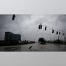 Traffic lights dangle over a Florida street after being destroyed during Hurricane Ian
