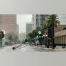 A traffic light hangs down in an Orlando street during Hurricane Ian