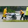 EMS workers carry a patient on a stretcher out of an Orlando nursing home during Hurricane Ian