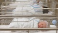 Stock image of newborn babies in a hospital nursery.
