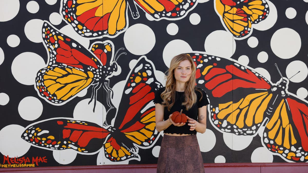 Skyler Samuels poses at Ogden, Utah, mural just as Gabby Petito did