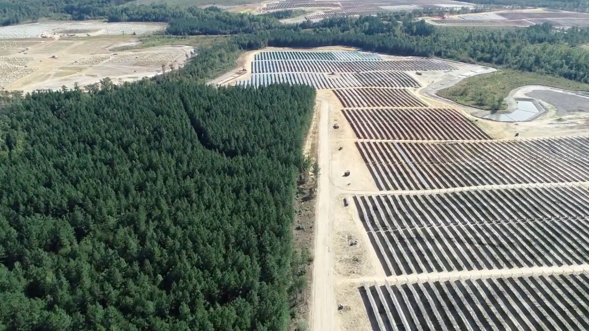 A flyover image shows deforestation caused by solar project development in rural Virginia.