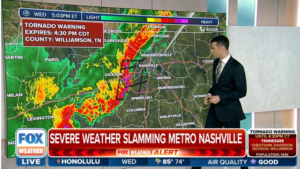 Fox Weather reporter in front of a map showing a line of storms
