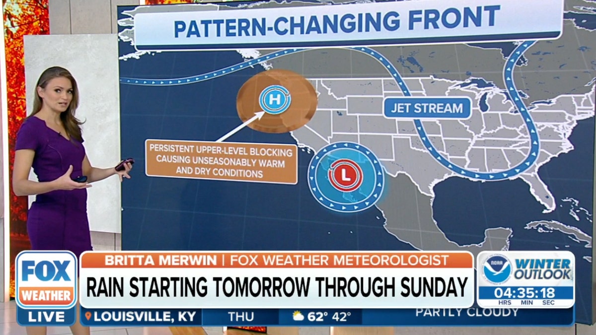 Meteorologist stands at the weather board 