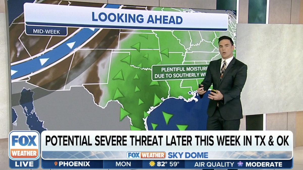 Weather reporter in front of map showing severe weather threat