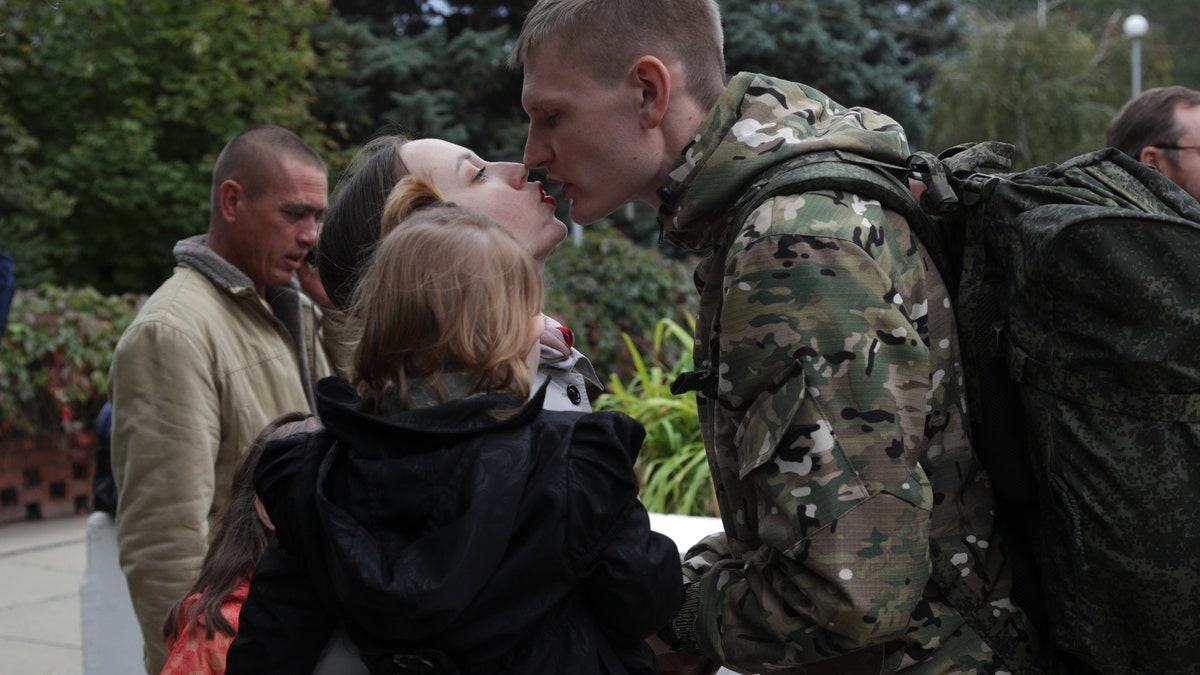 Russians embracing, kissing
