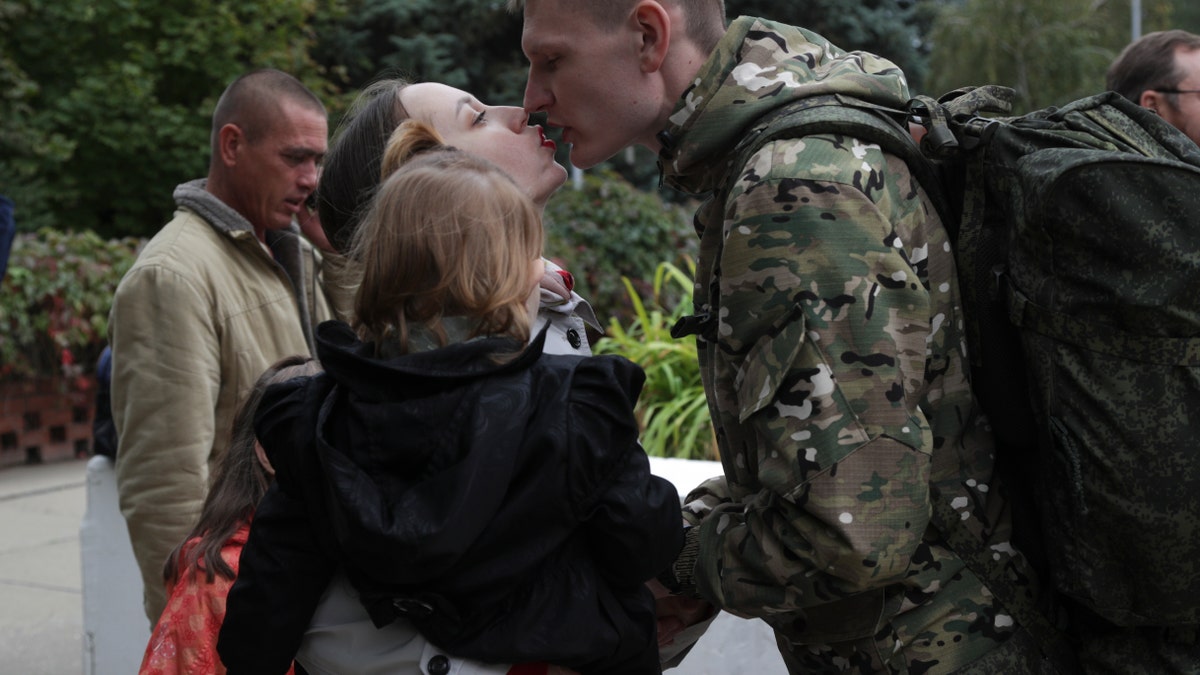 Russians embracing, kissing