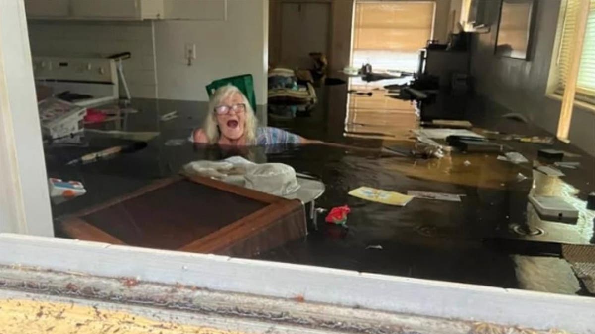 Woman submerged in flood waters