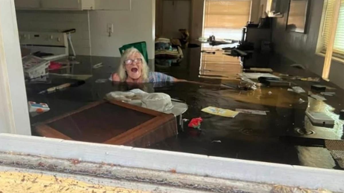 Woman submerged in flood waters