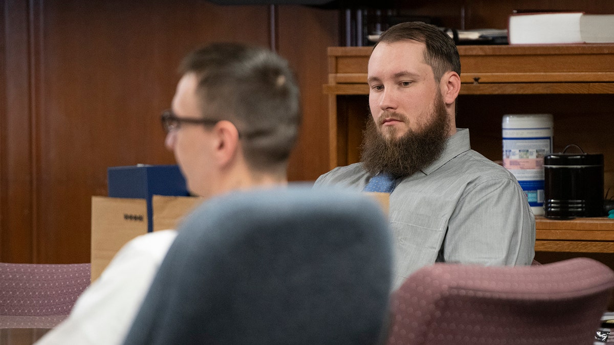 Joseph Morrison sits in court