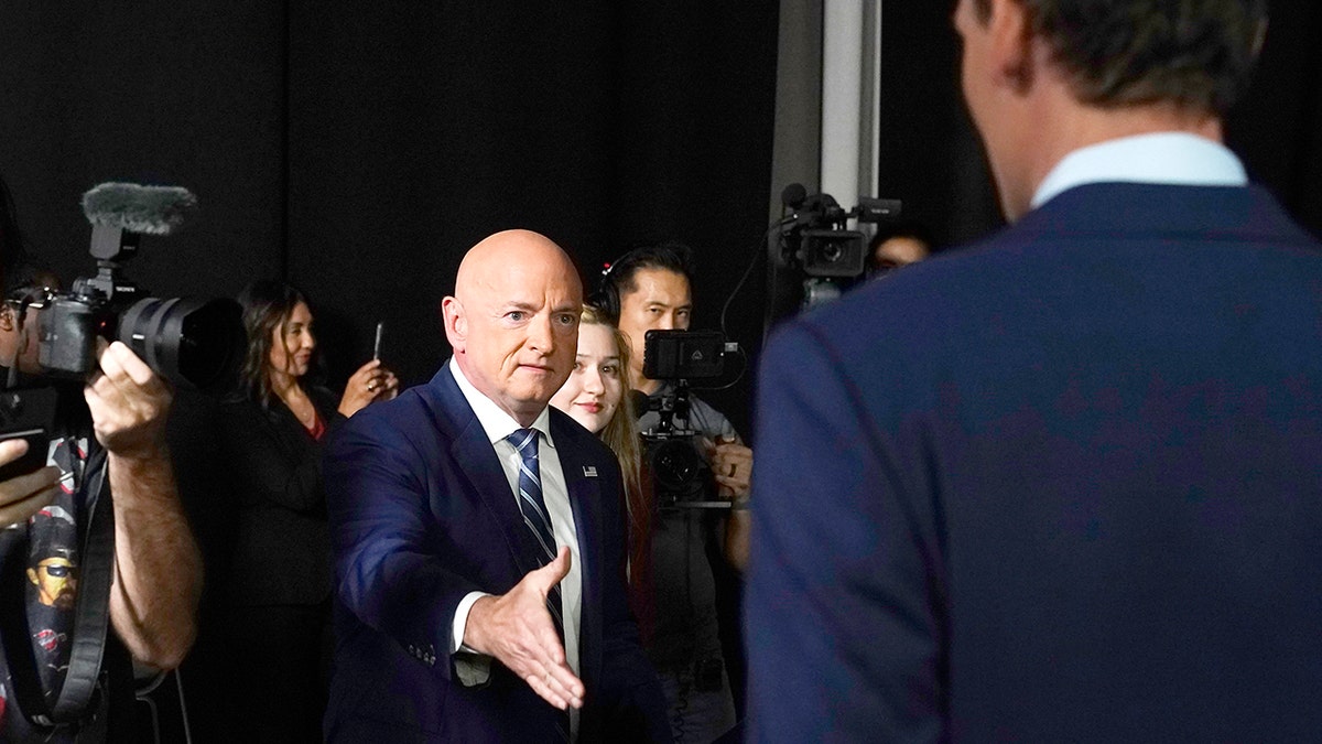 Mark Kelly extends his hand to shake hands