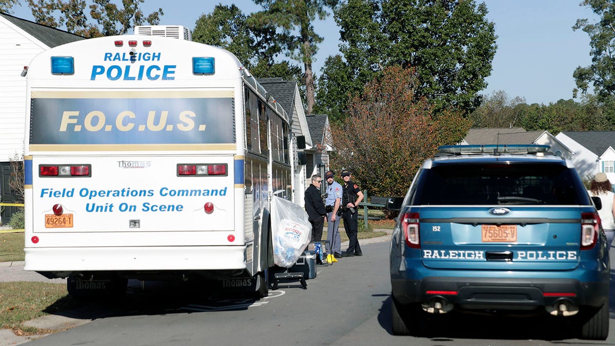 Raleigh police and north carolina officials gather at crime scene