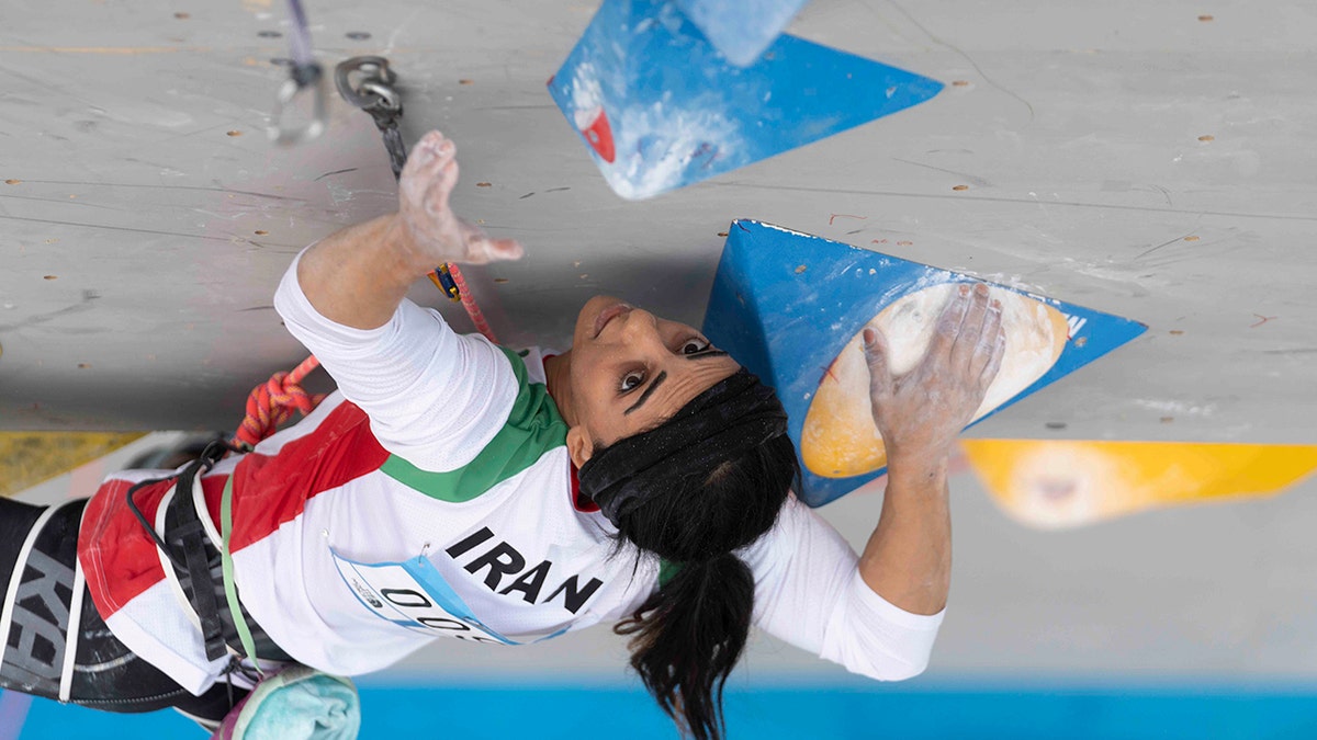 Elnaz Rekabi in climbing maneuver 