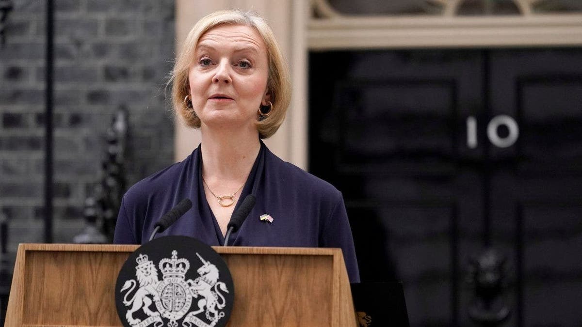 Liz Truss speaks at podium out front of 10 Downing Street