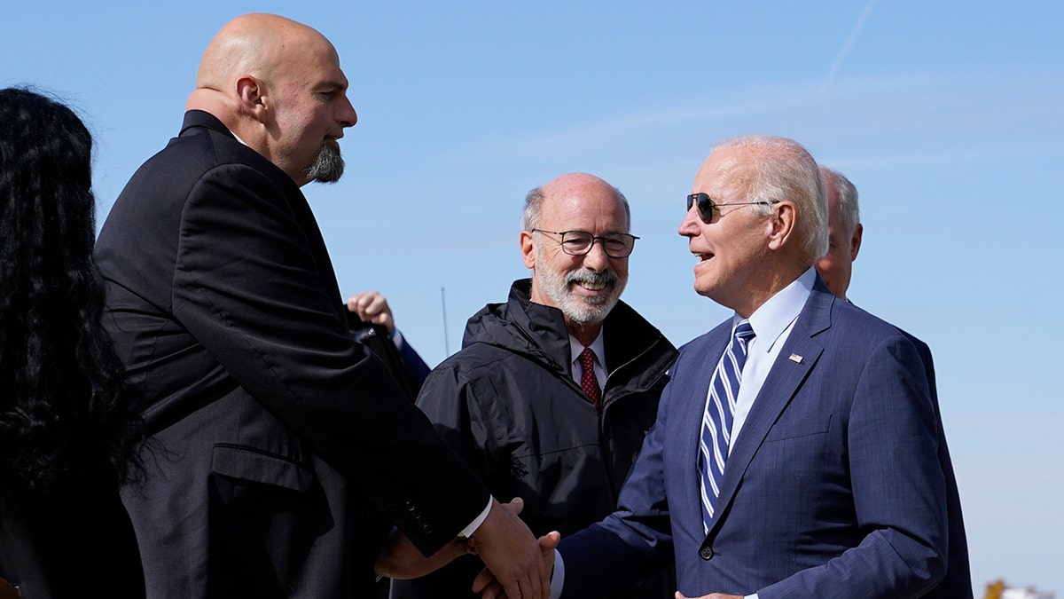 A photo of Joe Biden speaking with John Fetterman