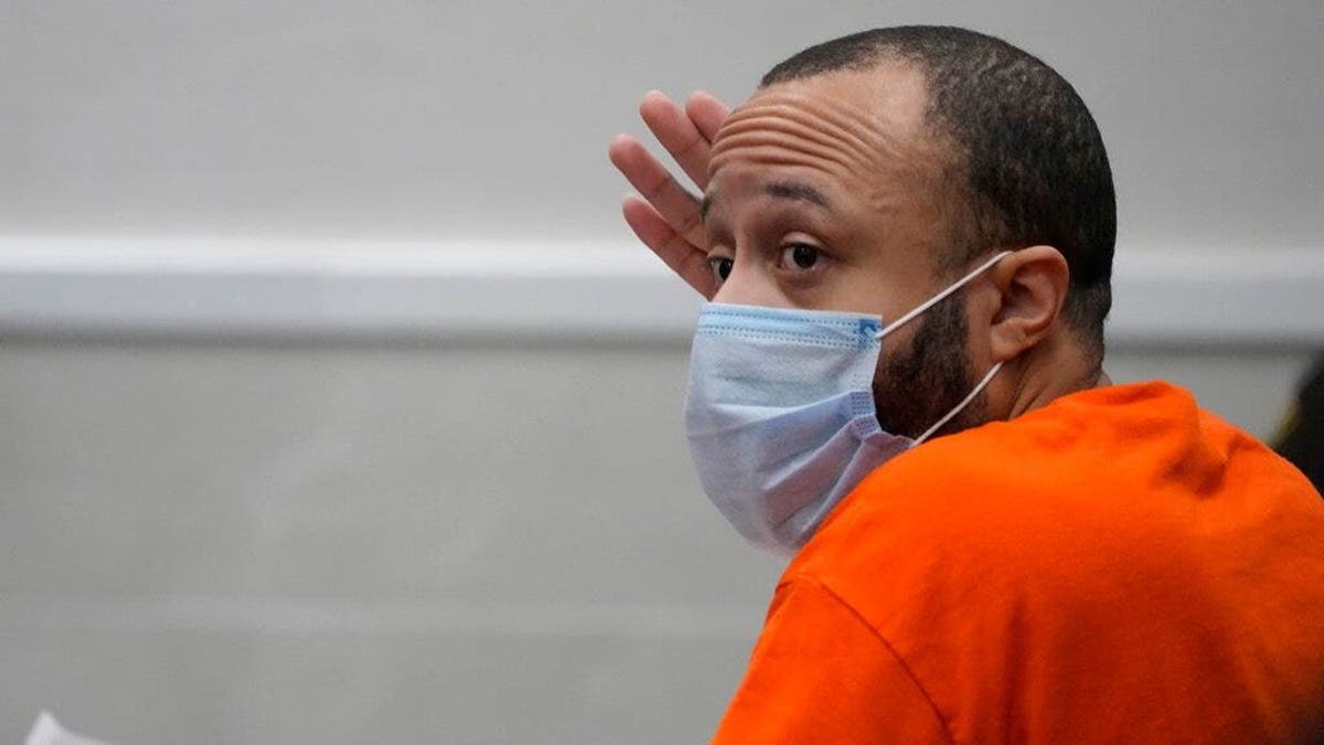 Darrell Brooks in face mask and jail jumpsuit in court
