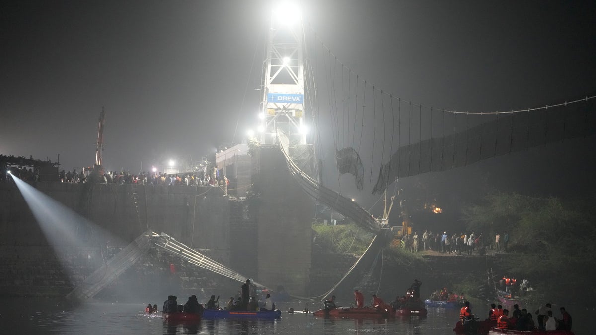 Boats in the water after a bridge collapse in India