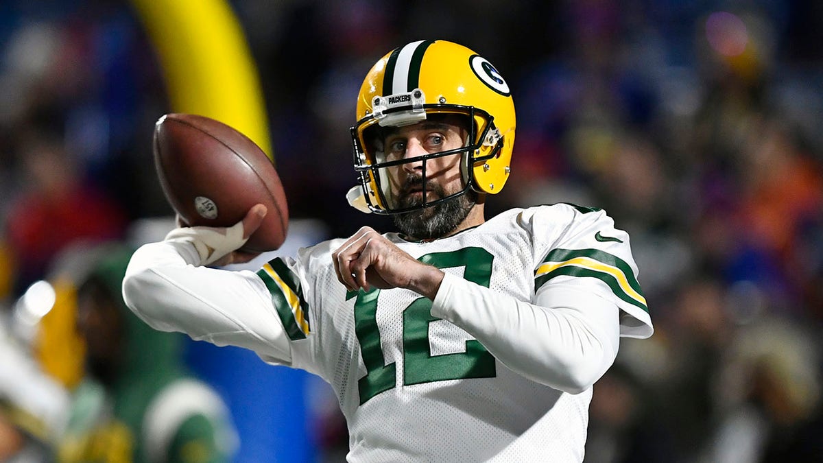 Aaron Rodgers tosses the ball in warm ups